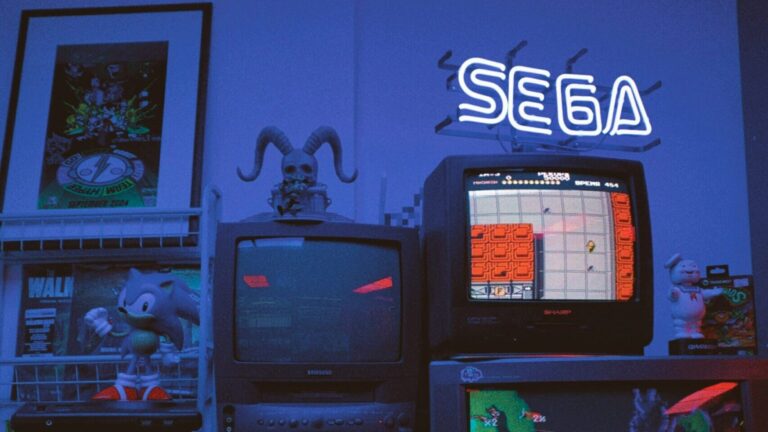 Mehrere gestapelte Röhrenfernseher, auf denen Retro-Videospiele laufen und Merchandise aus verschiedenen Videospielen